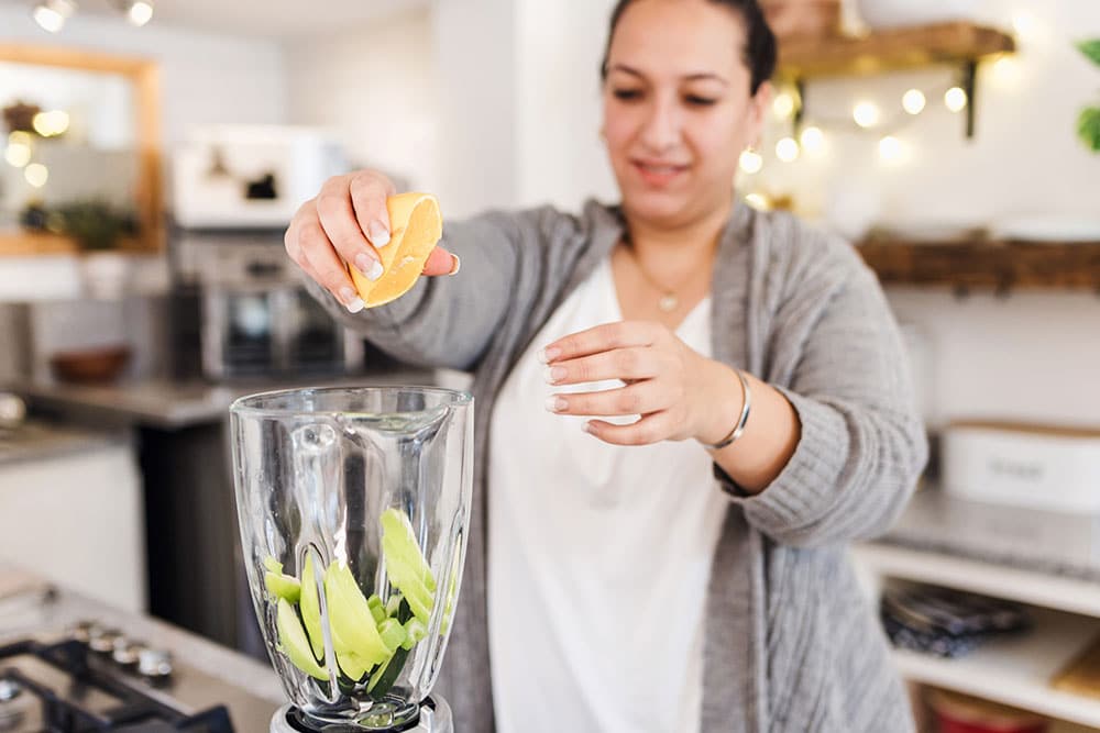 Female making healthy drink to help manage weight