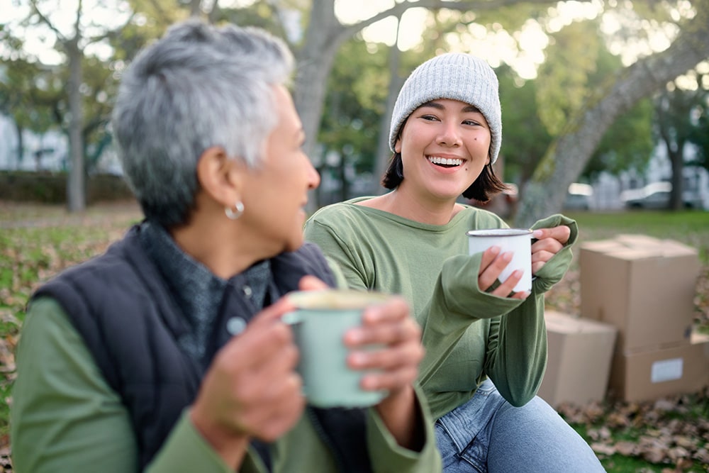 Volunteers sat outside chatting with a hot drink