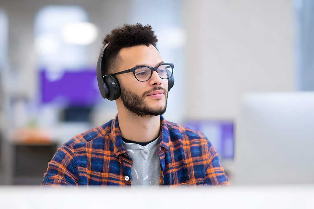 Neurodiverse employee sat at his desk at work